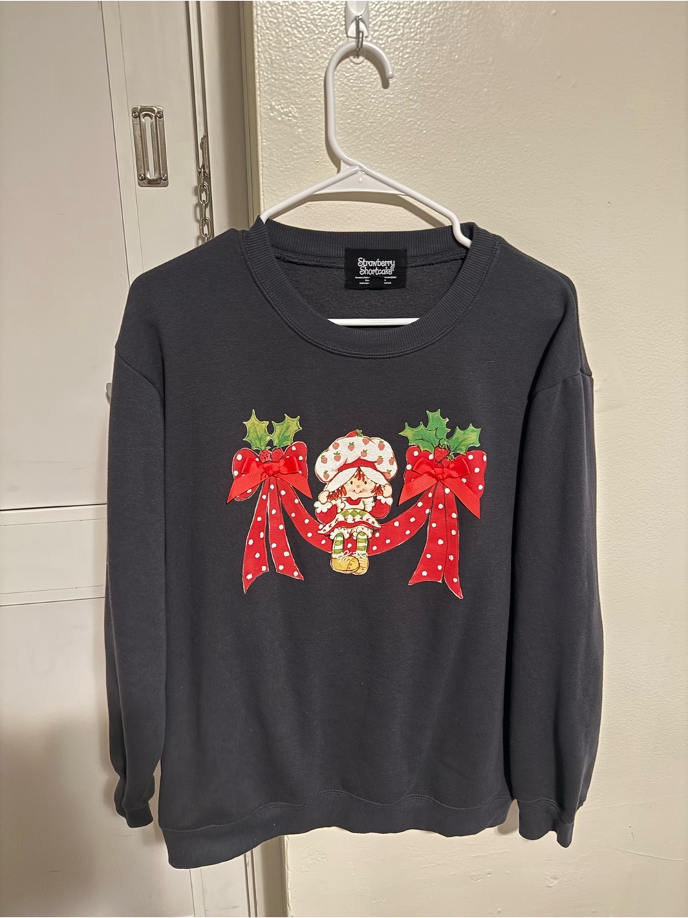 Strawberry Shortcake Black Crewneck Sweater with Holiday Bow Graphic